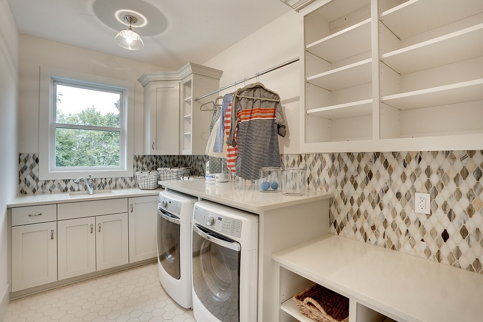 Inspiration for a large classic l-shaped separated utility room in Minneapolis with a submerged sink, white cabinets, laminate countertops, beige walls, porcelain flooring, a side by side washer and dryer and shaker cabinets.