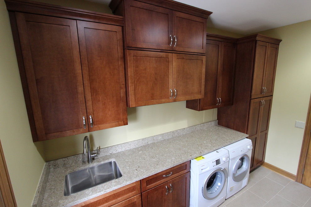 Medium sized traditional galley utility room in Cleveland with a single-bowl sink, shaker cabinets, dark wood cabinets, engineered stone countertops, porcelain flooring, a side by side washer and dryer and beige walls.