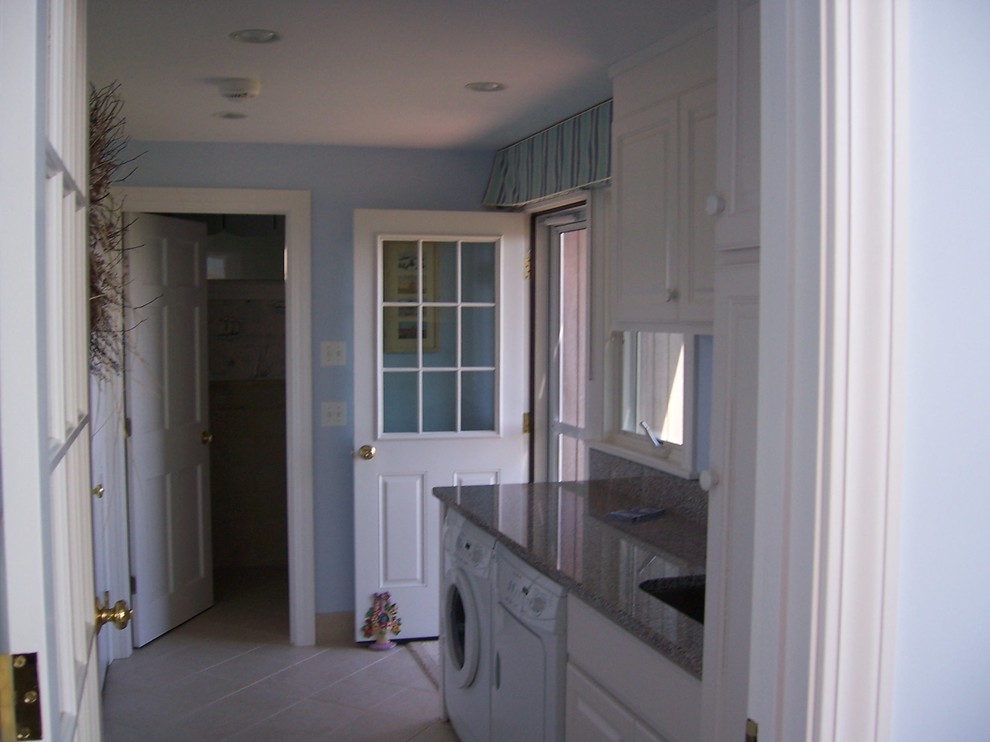 Photo of a medium sized traditional single-wall separated utility room in Boston with beaded cabinets, white cabinets, blue walls, a side by side washer and dryer, a submerged sink, granite worktops, ceramic flooring and beige floors.
