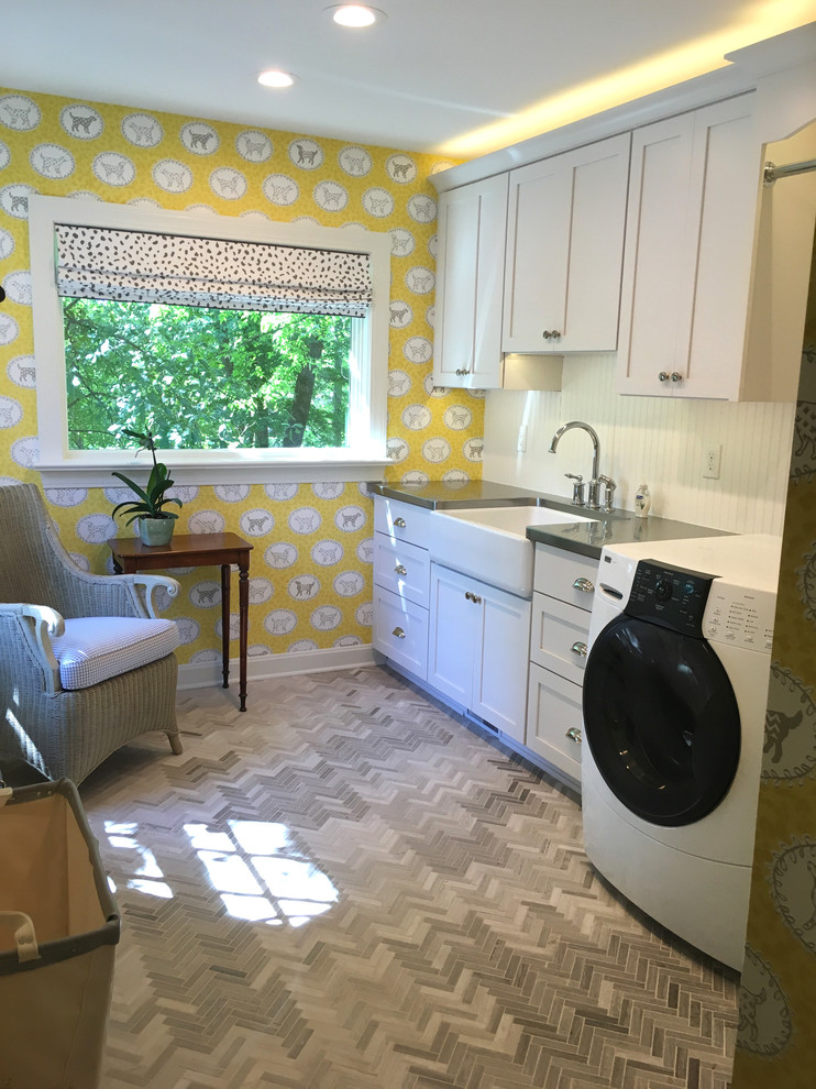 Example of a mid-sized classic single-wall marble floor dedicated laundry room design in Louisville with a farmhouse sink, shaker cabinets, white cabinets, stainless steel countertops, yellow walls and a side-by-side washer/dryer