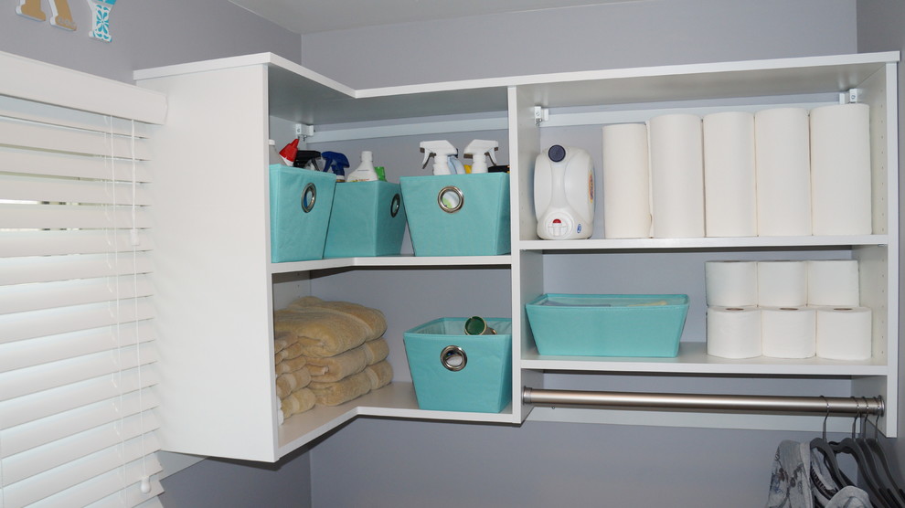 Small l-shaped dedicated laundry room photo in Detroit with flat-panel cabinets, white cabinets and a side-by-side washer/dryer