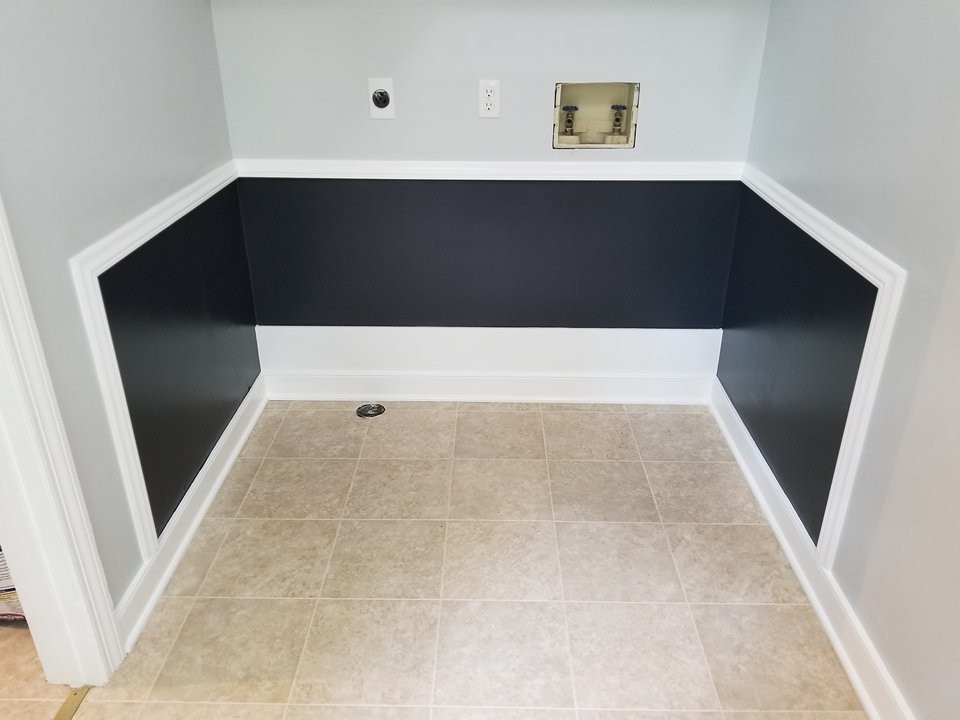 Exempel på en modern tvättstuga, med grå väggar, laminatgolv, en tvättmaskin och torktumlare bredvid varandra och beiget golv