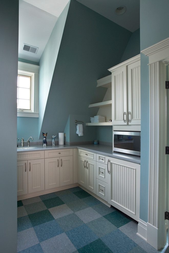 Inspiration for a large classic u-shaped utility room in Milwaukee with a submerged sink, beaded cabinets, white cabinets, composite countertops, blue walls and lino flooring.