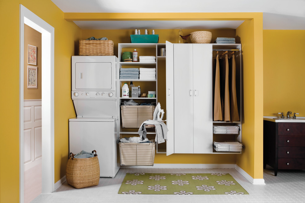 This is an example of a medium sized contemporary single-wall utility room in Boston with a submerged sink, flat-panel cabinets, white cabinets, ceramic flooring, a stacked washer and dryer and orange walls.
