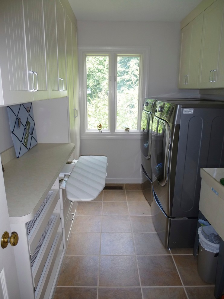 Design ideas for a medium sized classic galley utility room in Other with an utility sink, beaded cabinets, beige cabinets, laminate countertops and a side by side washer and dryer.