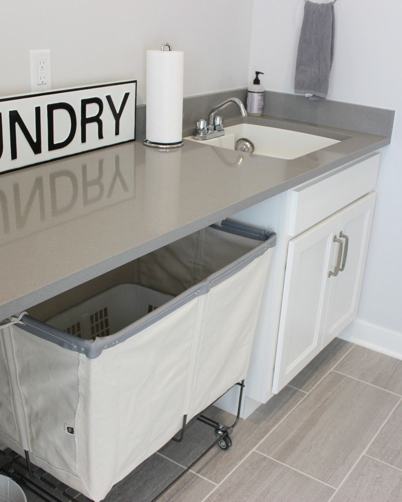 Medium sized traditional single-wall separated utility room in Other with a submerged sink, flat-panel cabinets, white cabinets, engineered stone countertops, ceramic flooring, a side by side washer and dryer, grey floors and grey worktops.