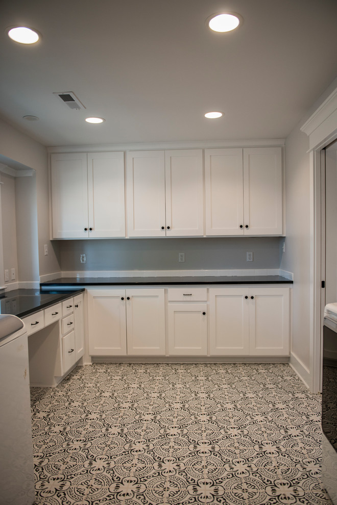 Inspiration for a large cottage porcelain tile and multicolored floor dedicated laundry room remodel in Kansas City with white cabinets, quartz countertops, gray walls, recessed-panel cabinets and a side-by-side washer/dryer