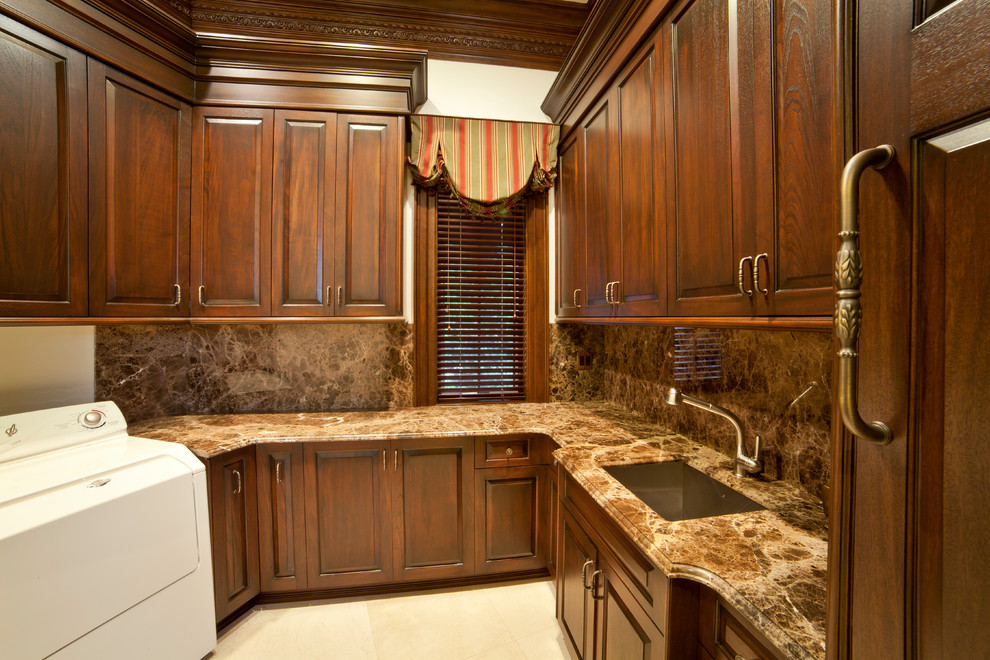Example of a mid-sized classic u-shaped ceramic tile and beige floor utility room design in New York with an undermount sink, raised-panel cabinets, dark wood cabinets, granite countertops, a side-by-side washer/dryer, white walls and multicolored countertops