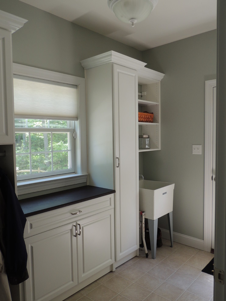 Design ideas for a medium sized traditional single-wall utility room in Philadelphia with raised-panel cabinets, laminate countertops and white cabinets.