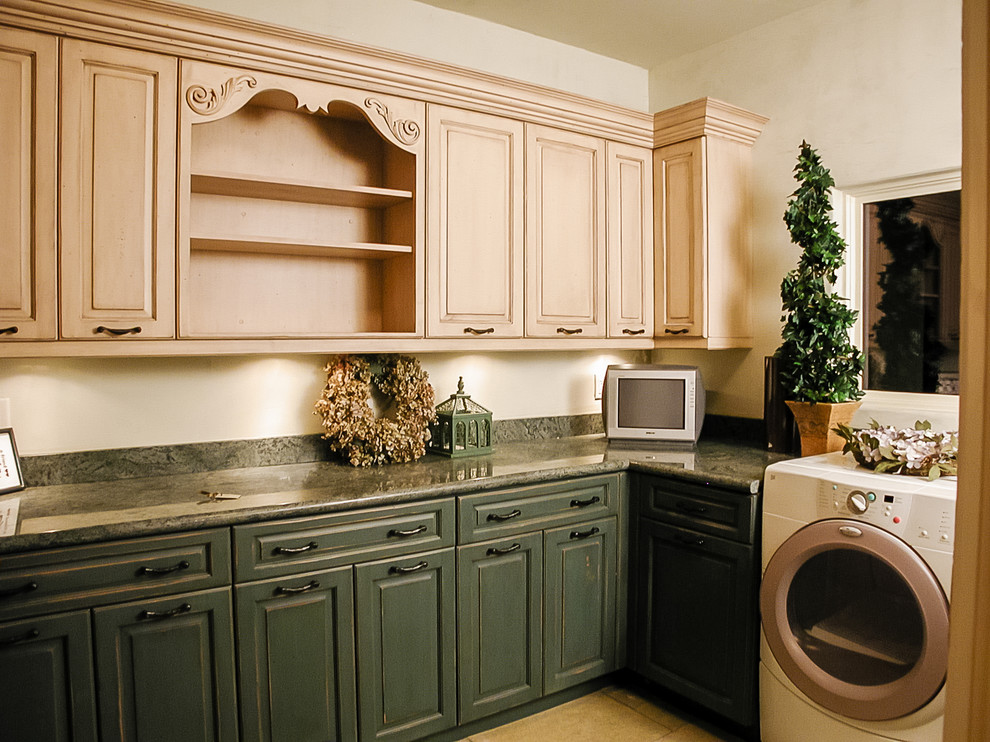 Example of a large classic u-shaped utility room design in Salt Lake City with raised-panel cabinets, distressed cabinets, granite countertops, white walls, a side-by-side washer/dryer and green countertops