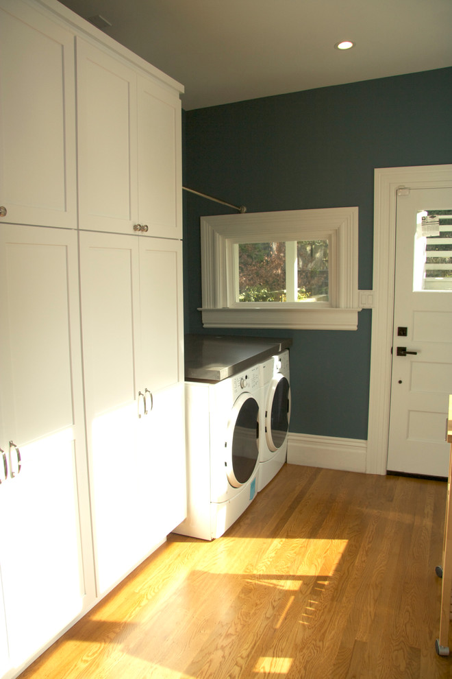 Medium sized classic single-wall utility room in San Francisco with shaker cabinets, white cabinets, composite countertops, blue walls, medium hardwood flooring and a side by side washer and dryer.
