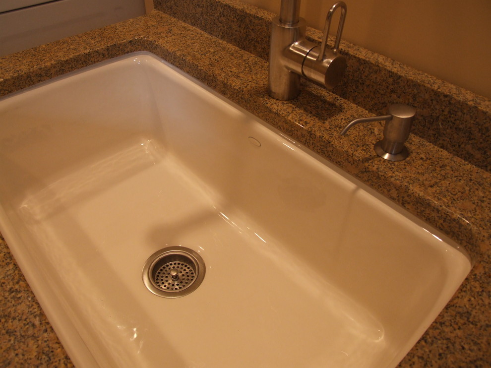 This is an example of a large rural galley utility room in New York with an utility sink, raised-panel cabinets, beige cabinets, beige walls, medium hardwood flooring, a side by side washer and dryer, granite worktops, brown floors, grey splashback, tonge and groove splashback, multicoloured worktops and tongue and groove walls.