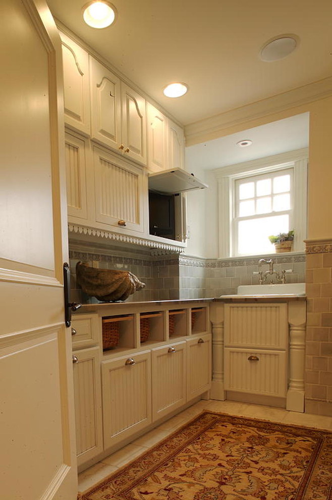 This is an example of a small farmhouse l-shaped utility room in New York with white cabinets, beige walls, ceramic flooring, a belfast sink, beaded cabinets, granite worktops and a side by side washer and dryer.