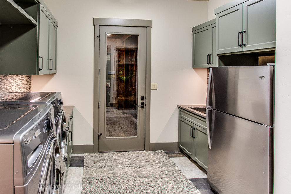 Design ideas for a medium sized traditional galley separated utility room in Austin with shaker cabinets, green cabinets, soapstone worktops, beige walls, ceramic flooring and a side by side washer and dryer.