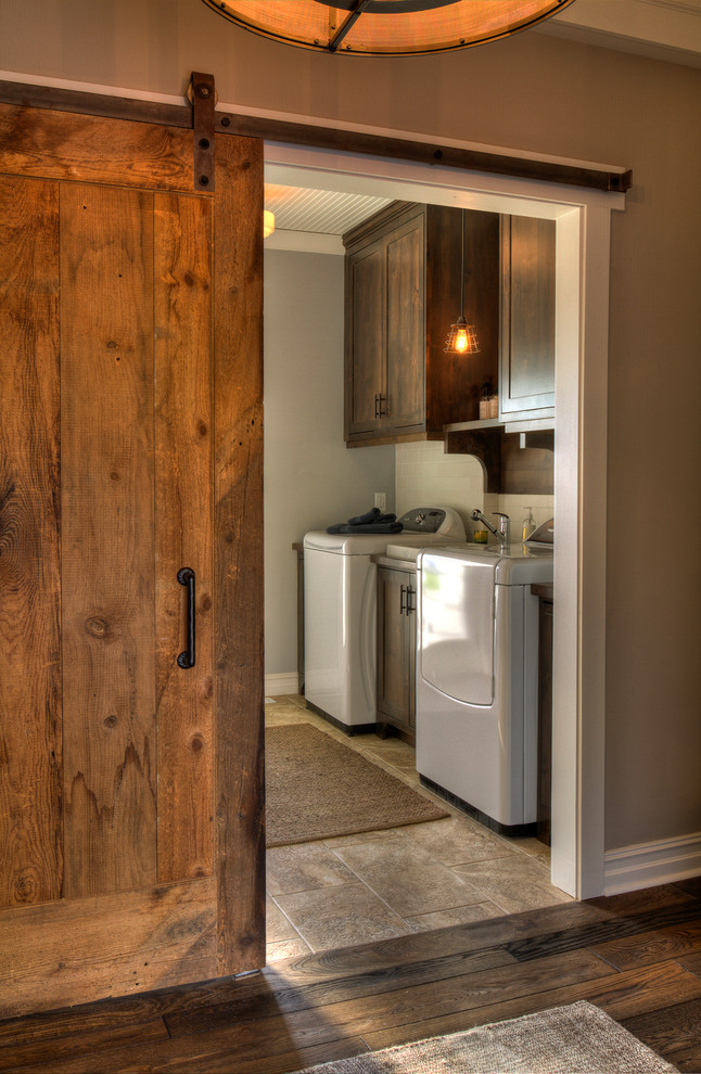 Design ideas for a medium sized rustic single-wall separated utility room in Minneapolis with a side by side washer and dryer, porcelain flooring, beige floors, shaker cabinets and dark wood cabinets.