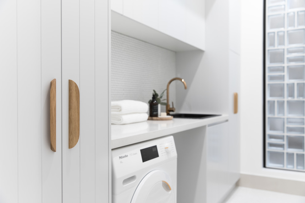 Example of a trendy laundry room design in Sydney