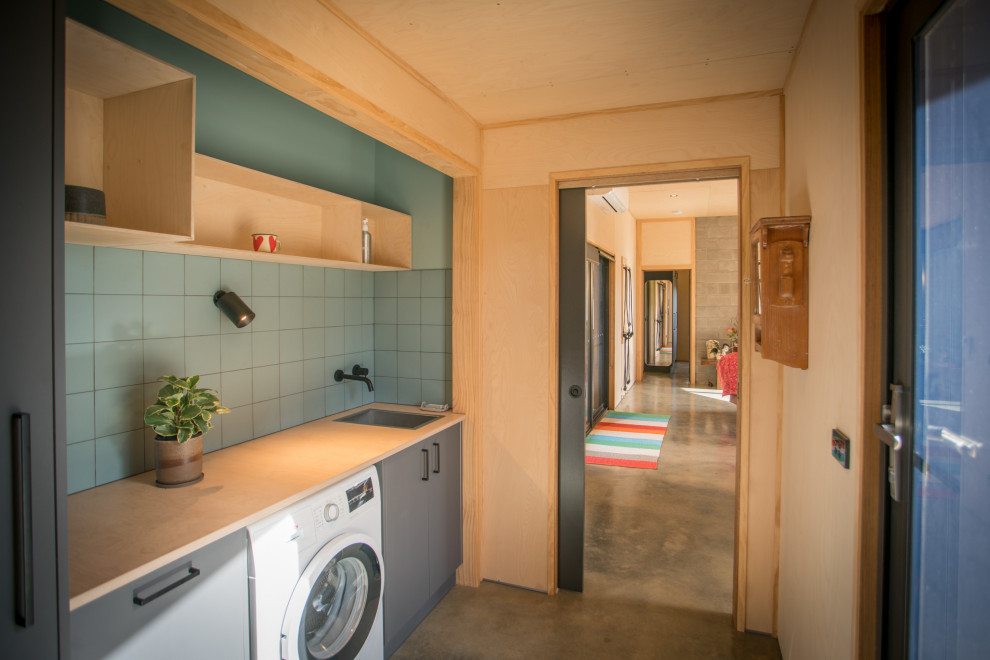 Photo of a small contemporary galley utility room in Other with a single-bowl sink, wood worktops, green splashback, ceramic splashback, green walls, concrete flooring, grey floors, a wood ceiling and wood walls.