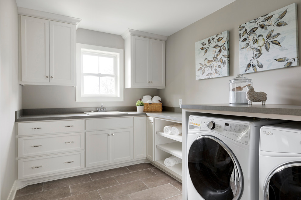 Inspiration for a mid-sized transitional l-shaped ceramic tile and gray floor dedicated laundry room remodel in Minneapolis with a drop-in sink, shaker cabinets, white cabinets, laminate countertops, gray walls, a side-by-side washer/dryer and gray countertops
