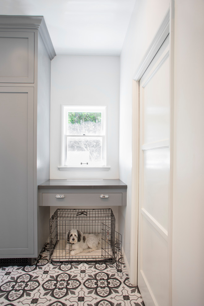 Photo of a medium sized traditional galley separated utility room in Los Angeles with a submerged sink, shaker cabinets, grey cabinets, composite countertops, grey walls, ceramic flooring, a side by side washer and dryer, multi-coloured floors and grey worktops.