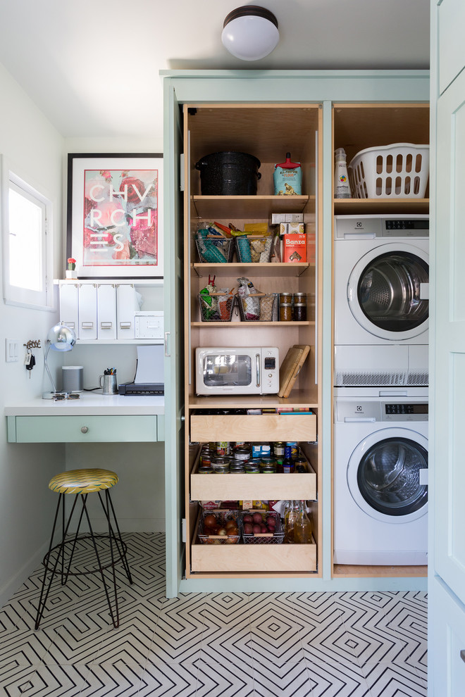 Eclectic multicolored floor utility room photo in Los Angeles with a stacked washer/dryer