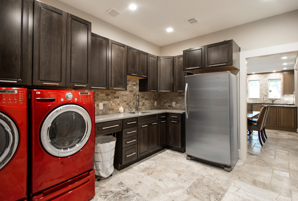 Laundry room - mid-sized traditional l-shaped travertine floor and beige floor laundry room idea in Dallas with an undermount sink, beaded inset cabinets, dark wood cabinets, quartz countertops, beige walls and a side-by-side washer/dryer