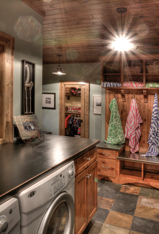 Example of a classic laundry room design in Minneapolis with black countertops