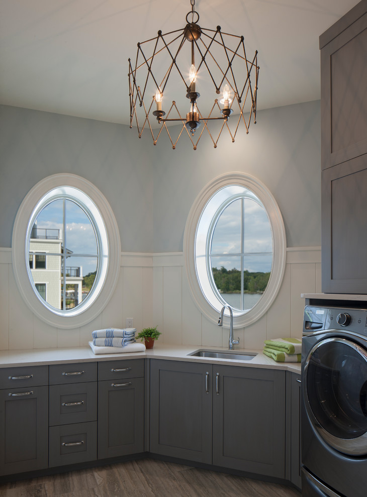 Immagine di una sala lavanderia stile marinaro con lavello sottopiano, ante grigie, top in quarzo composito, pareti blu e ante in stile shaker