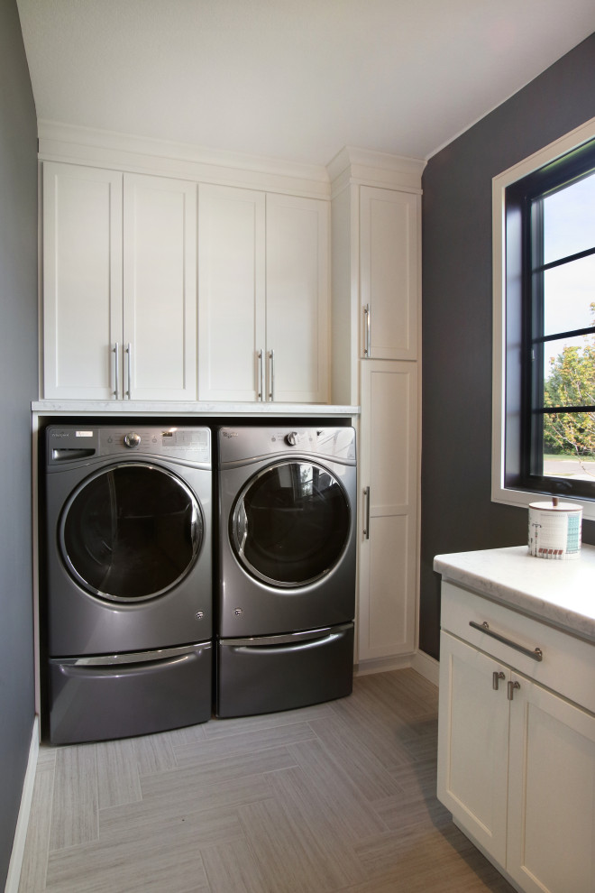 Utility room - mid-sized traditional u-shaped laminate floor and gray floor utility room idea in Minneapolis with flat-panel cabinets, white cabinets, laminate countertops, gray walls, a side-by-side washer/dryer and white countertops