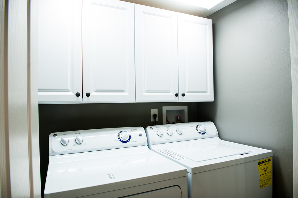 This is an example of a medium sized retro single-wall separated utility room with shaker cabinets, white cabinets, grey walls and a side by side washer and dryer.