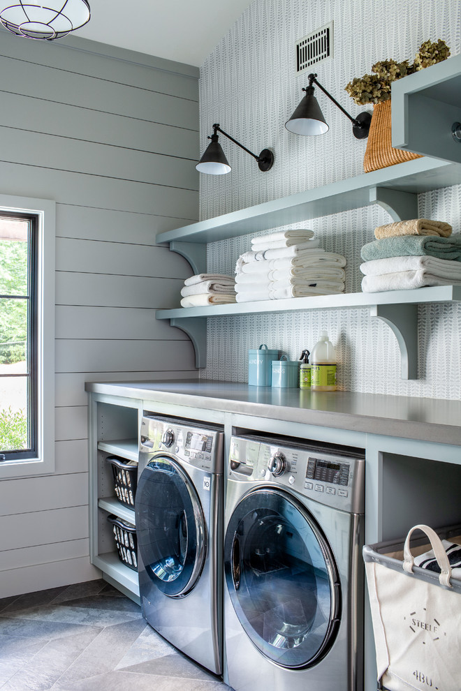 Example of a farmhouse gray floor laundry room design in Atlanta with open cabinets, blue cabinets, gray walls, a side-by-side washer/dryer and gray countertops