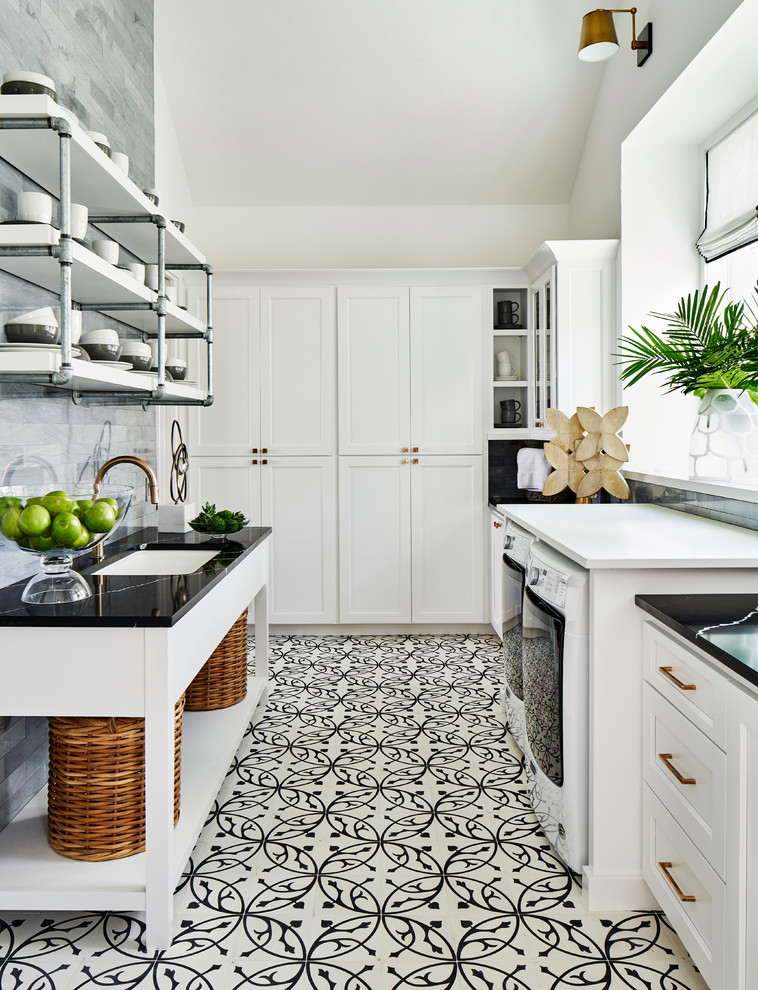 Transitional galley multicolored floor utility room photo in Other with an undermount sink, shaker cabinets, white cabinets, white walls, a side-by-side washer/dryer and black countertops