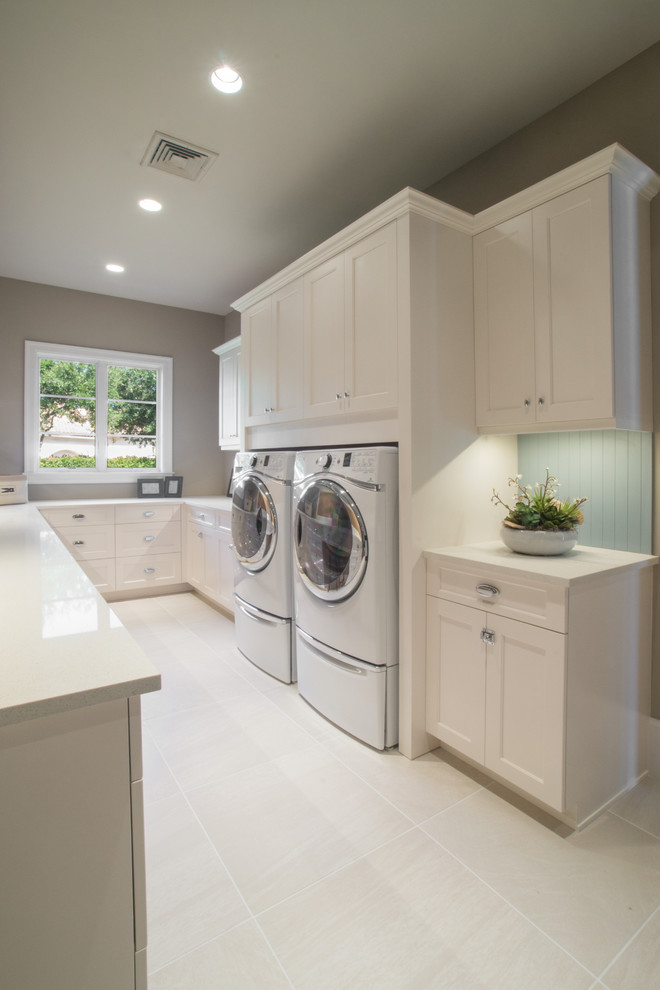 Example of a transitional u-shaped laundry room design in Miami with shaker cabinets, white cabinets and quartz countertops