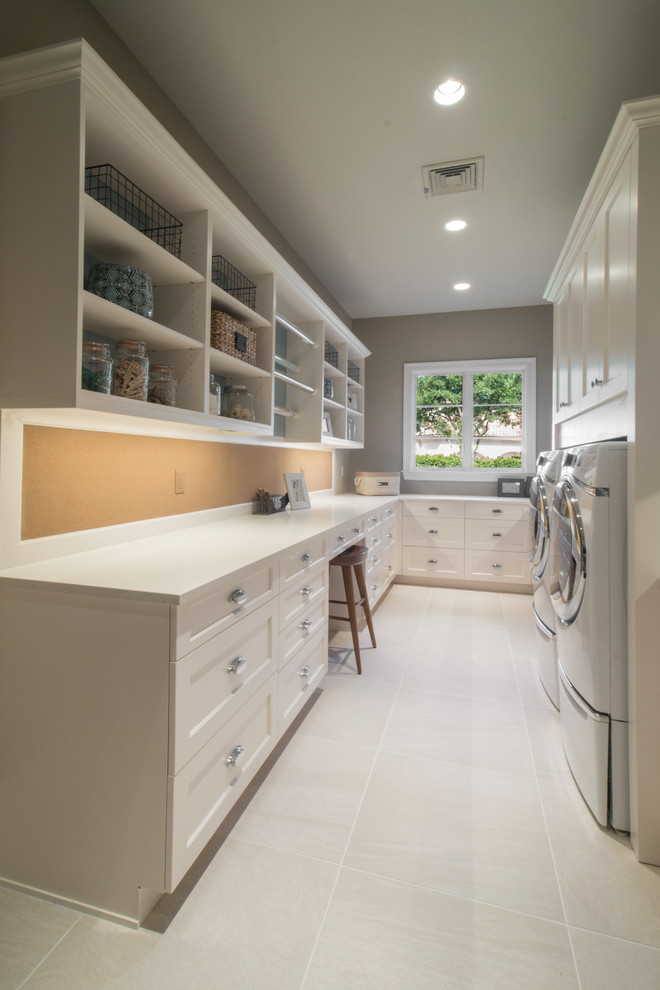Example of a transitional u-shaped laundry room design in Miami with shaker cabinets, white cabinets and quartz countertops