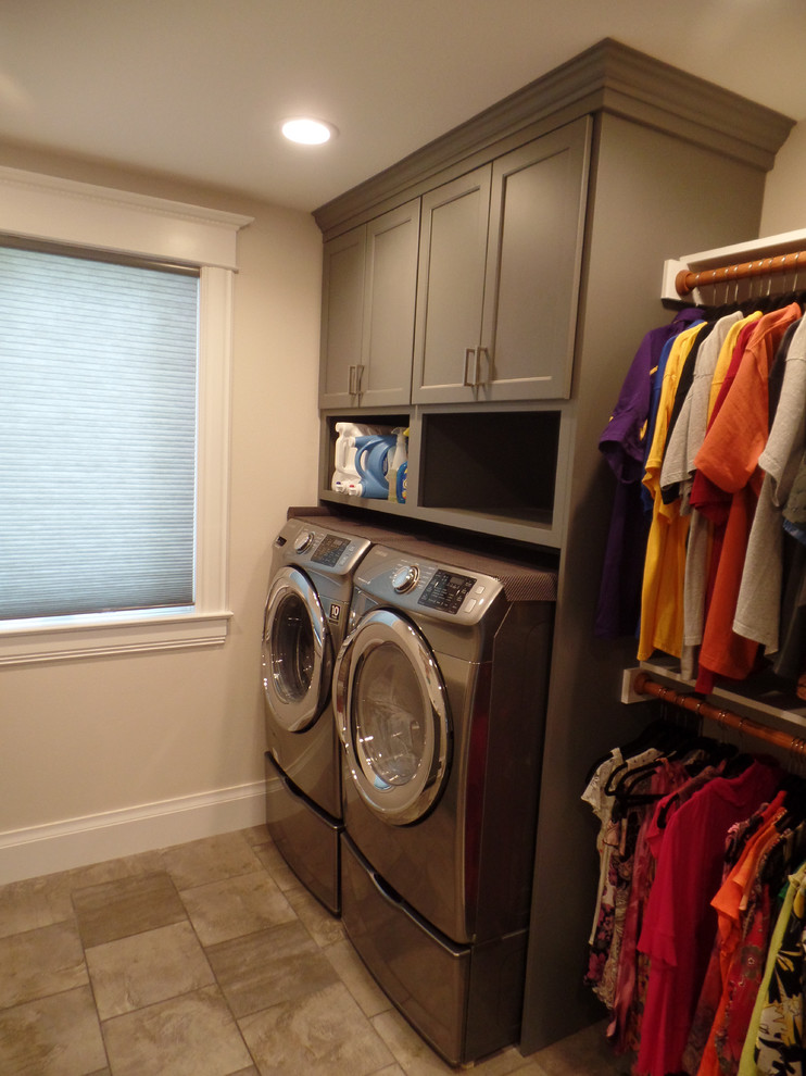 Inspiration for a mid-sized transitional porcelain tile laundry room remodel in Cedar Rapids with flat-panel cabinets, gray cabinets, a side-by-side washer/dryer and beige walls