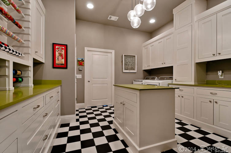 Design ideas for a classic utility room in New York with flat-panel cabinets, white cabinets, composite countertops, porcelain flooring and a side by side washer and dryer.