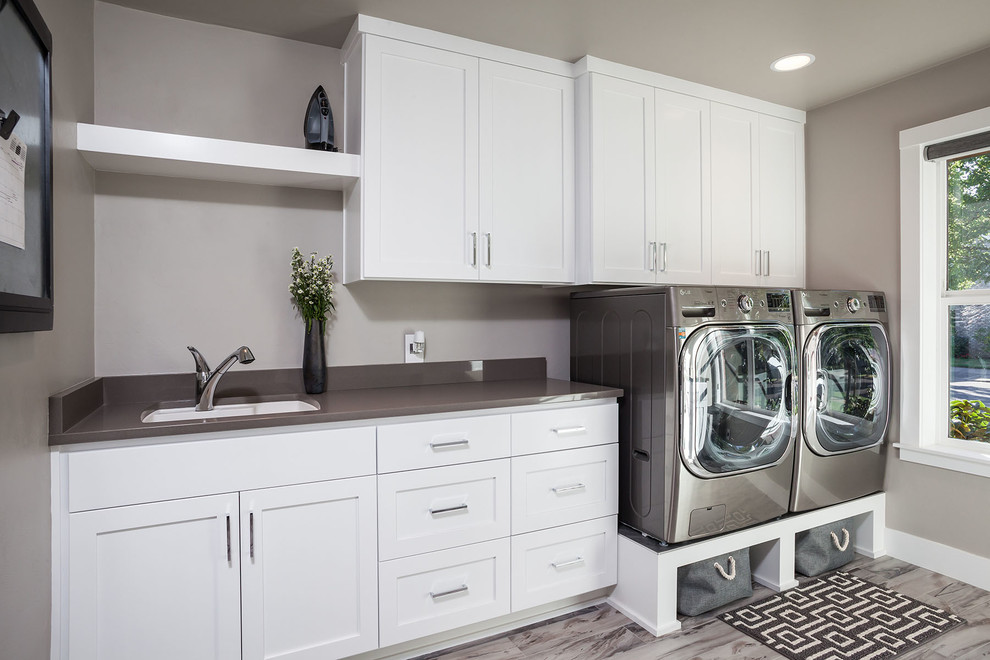 Inspiration for a large galley porcelain tile dedicated laundry room remodel in Other with an undermount sink, shaker cabinets, white cabinets, quartz countertops, gray walls and a side-by-side washer/dryer