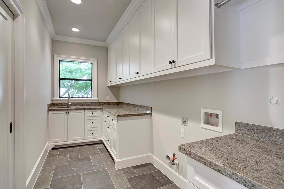 Inspiration for a large transitional u-shaped slate floor and gray floor utility room remodel in Houston with an undermount sink, shaker cabinets, white cabinets, granite countertops, gray walls, a side-by-side washer/dryer and gray countertops