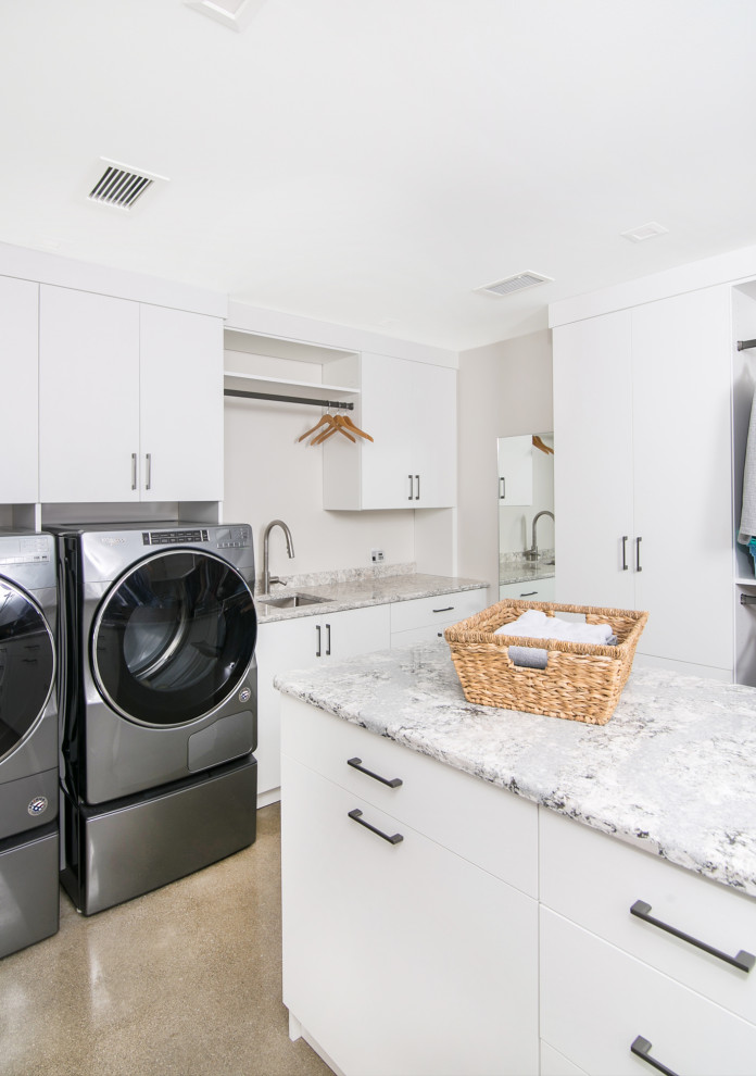 Mid-sized minimalist u-shaped concrete floor laundry closet photo in Detroit with an undermount sink, flat-panel cabinets, white cabinets, quartzite countertops, white walls and a side-by-side washer/dryer