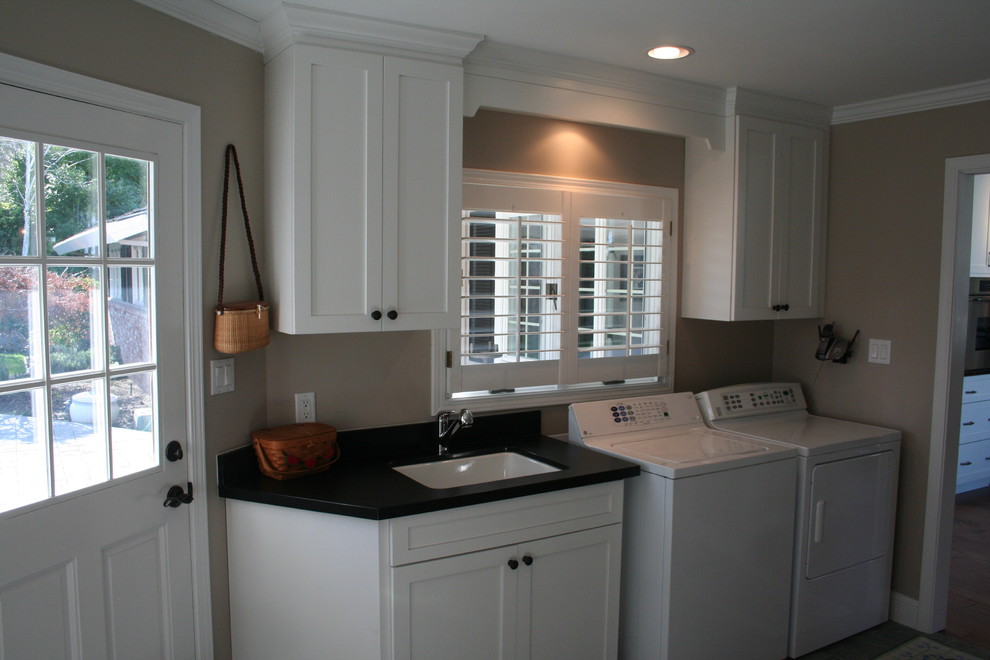 Large classic u-shaped utility room in San Francisco with a submerged sink, recessed-panel cabinets, white cabinets, granite worktops, dark hardwood flooring and black worktops.