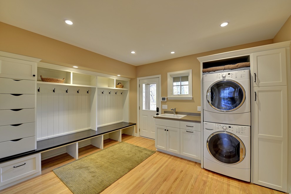 Elegant laundry room photo in Minneapolis with a stacked washer/dryer