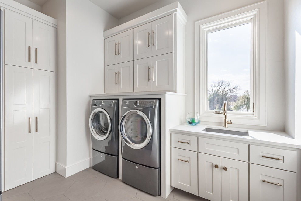 Laundry room - transitional laundry room idea in Oklahoma City with an undermount sink, shaker cabinets, white cabinets, white walls and a side-by-side washer/dryer