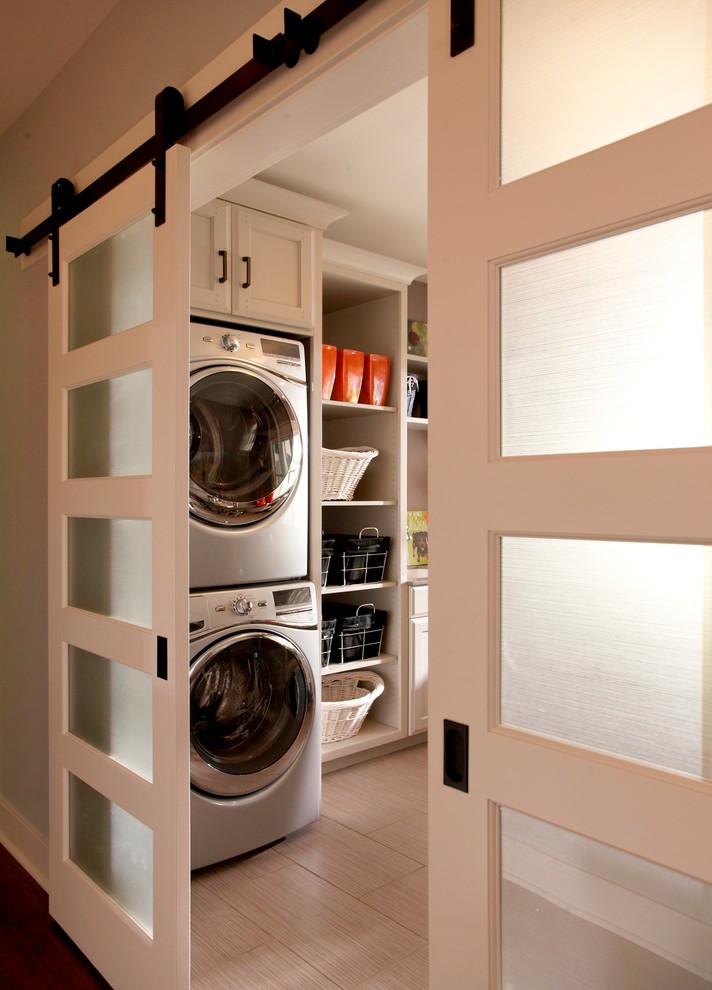 Inspiration for a timeless laundry room remodel in Detroit with a stacked washer/dryer