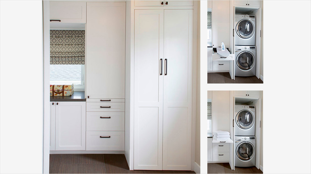 Inspiration for a traditional single-wall utility room in Los Angeles with recessed-panel cabinets, white cabinets, white walls, a stacked washer and dryer, brown floors, grey worktops, concrete worktops and dark hardwood flooring.