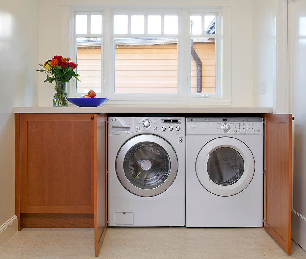 Example of an arts and crafts single-wall laundry room design in San Francisco with an undermount sink, shaker cabinets, medium tone wood cabinets and quartz countertops