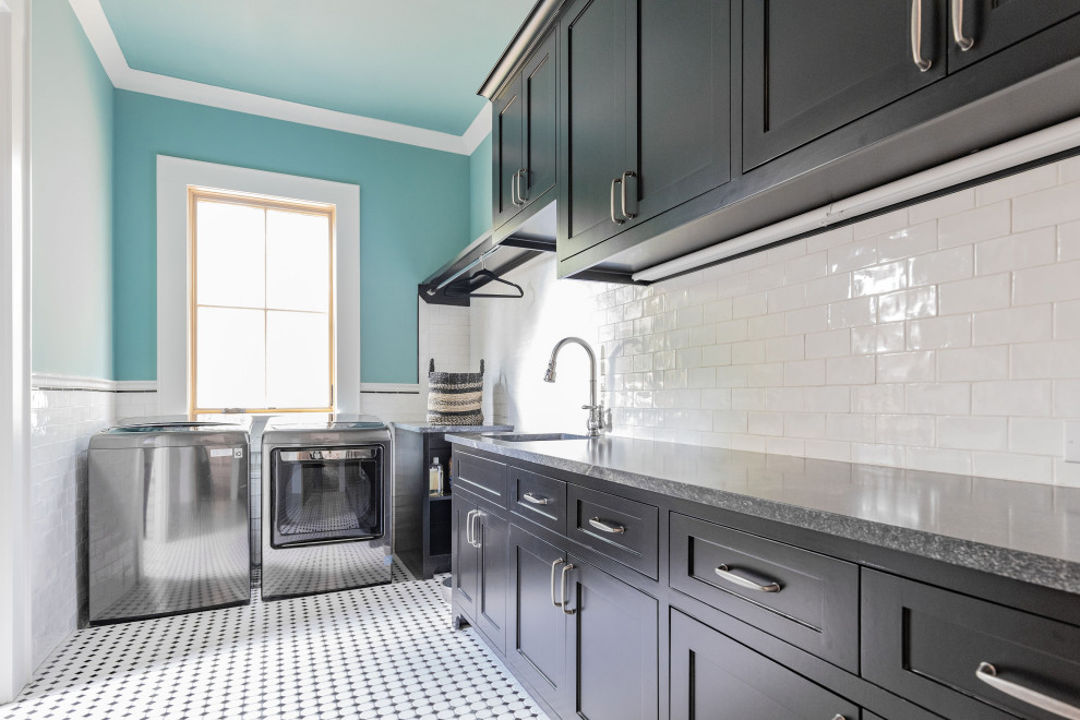 Large farmhouse l-shaped separated utility room in Houston with a submerged sink, shaker cabinets, black cabinets, granite worktops, blue walls, ceramic flooring, a side by side washer and dryer, multi-coloured floors and black worktops.