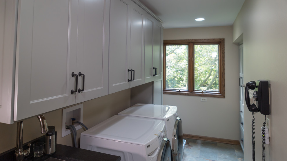 Utility room - mid-sized country galley slate floor and multicolored floor utility room idea in Chicago with an undermount sink, shaker cabinets, gray cabinets, granite countertops and a side-by-side washer/dryer