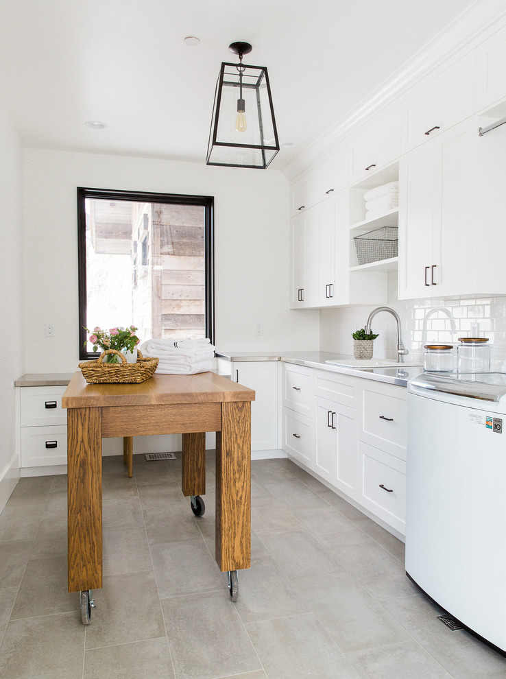Photo of a classic utility room in Salt Lake City with a built-in sink, flat-panel cabinets, white cabinets, stainless steel worktops and white walls.