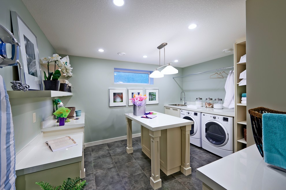 Inspiration for a large modern u-shaped utility room remodel in Other with an utility sink, beige cabinets, gray walls and a side-by-side washer/dryer