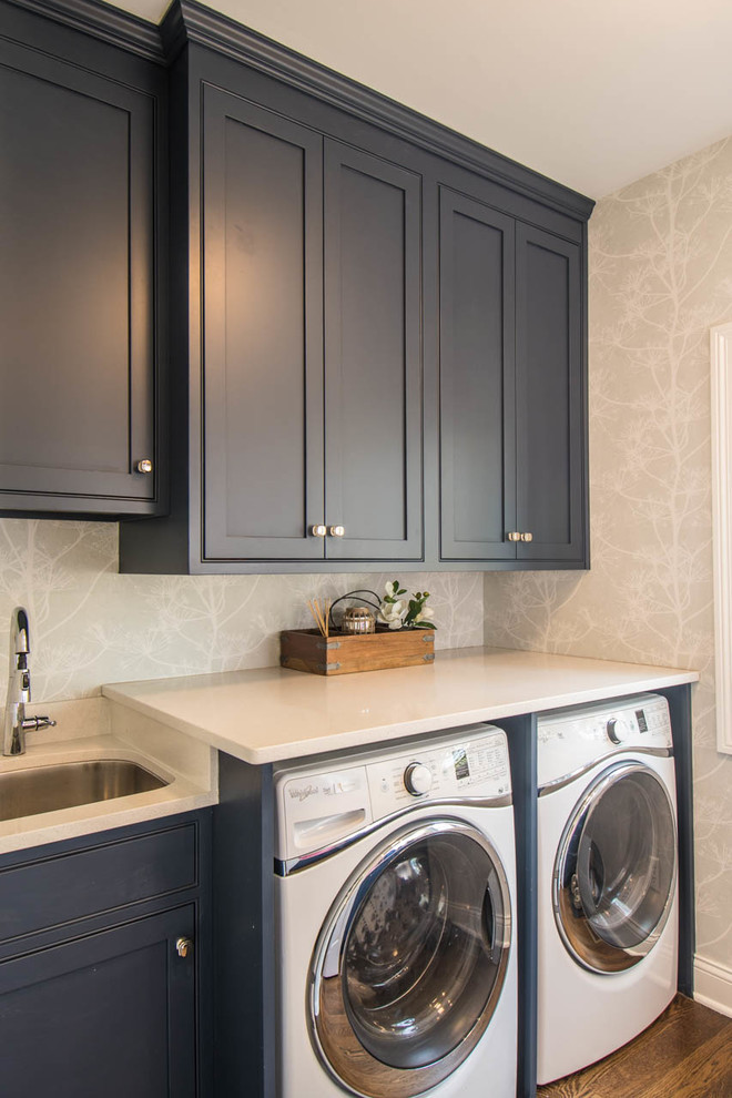 This is an example of a medium sized classic utility room in Indianapolis with a submerged sink, recessed-panel cabinets, blue cabinets, engineered stone countertops, multi-coloured walls, medium hardwood flooring, a side by side washer and dryer and white worktops.