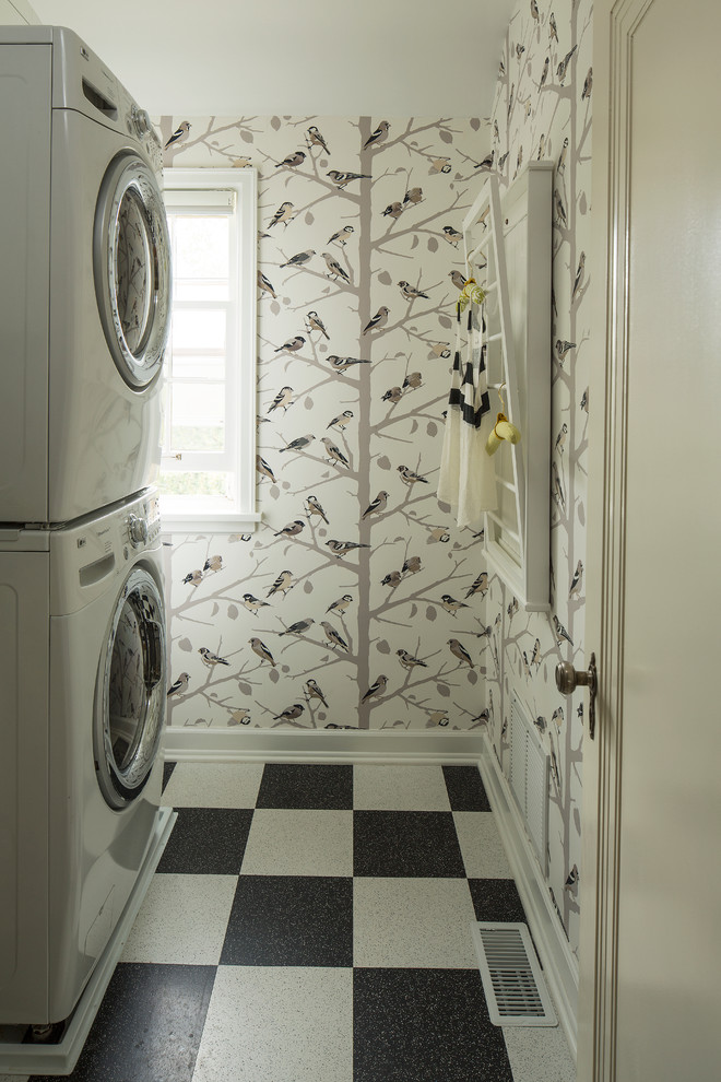 Inspiration for an eclectic utility room in Minneapolis with a stacked washer and dryer and multi-coloured floors.